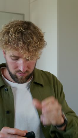 man with curly hair and earbuds