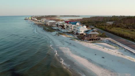 aerial shot of luxurious beach front homes raised up on stilts on the gulf of mexico