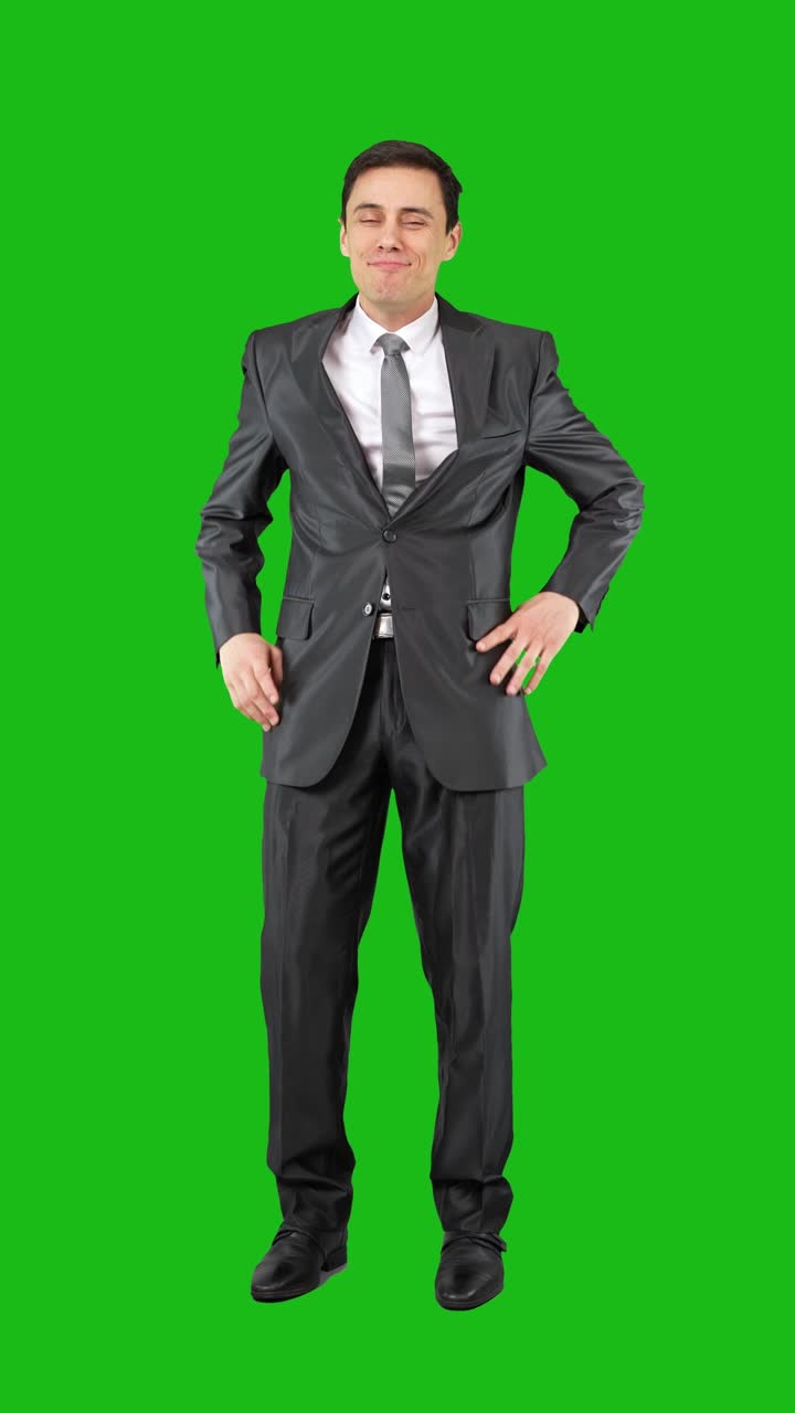 Businessman stretching and relaxing on a green screen