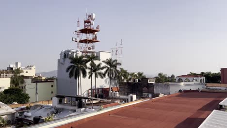 urban rooftop view with radio towers and palm trees in cuernavaca centro