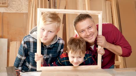 father and sons in a workshop