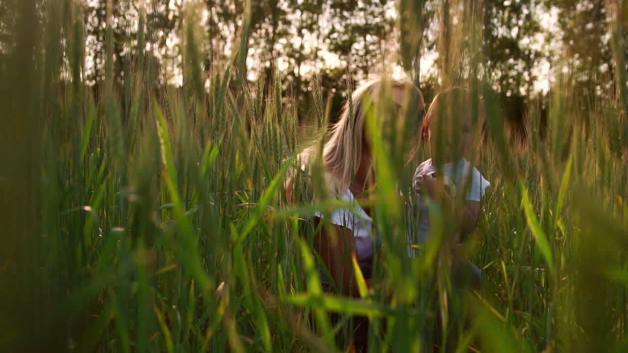 Loving mother and son in the field to communicate and hug, the sun's rays illuminate the hair. Happy family