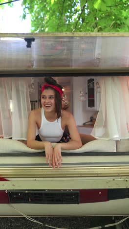 woman smiling in camper window