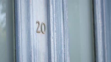 close-up of house number 20 on a blue door