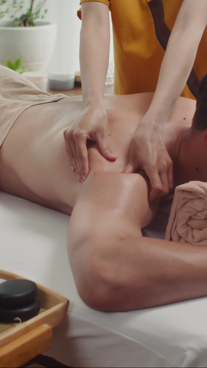 Male Client Getting Back Massage at Spa Salon