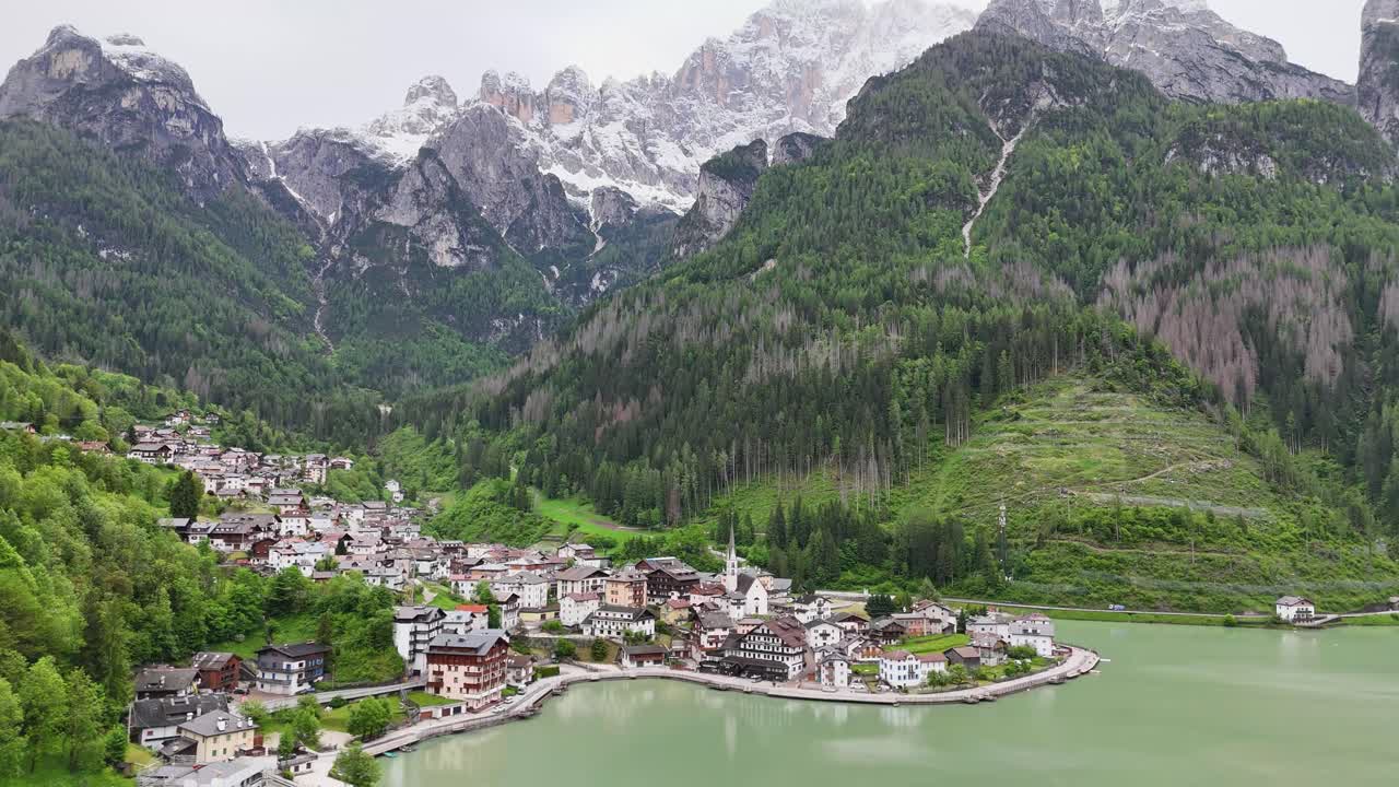 Alleghe village cinematic drone shot showing lake, forest, and mountain range