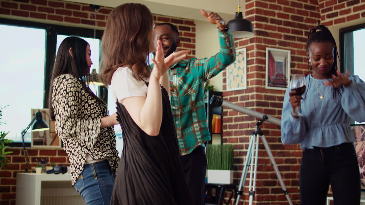 Friends hanging around house, busting dance moves to disco music in cozy living room