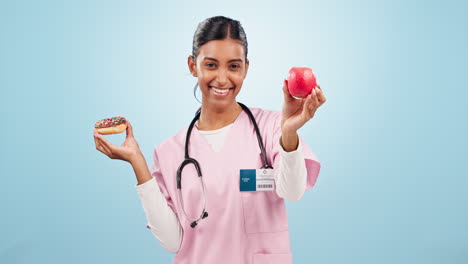 Woman-nurse-with-apple-and-donut-for-choice