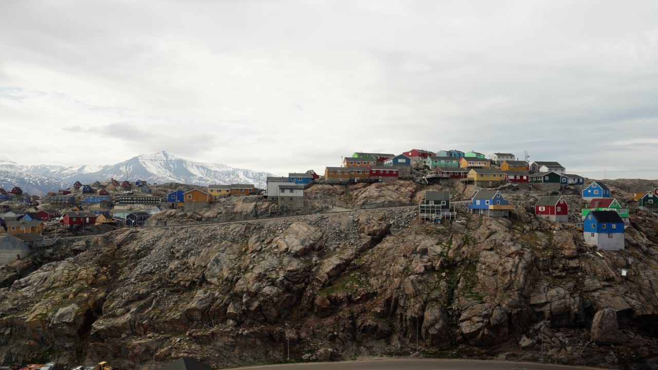 Flying over the city of Uummannaq, shot handheld out of the local helicopter