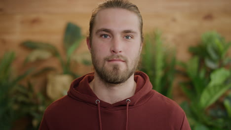 portrait-of-happy-young-blonde-man-looking-at-camera-attractive-bearded-male-slow-motion