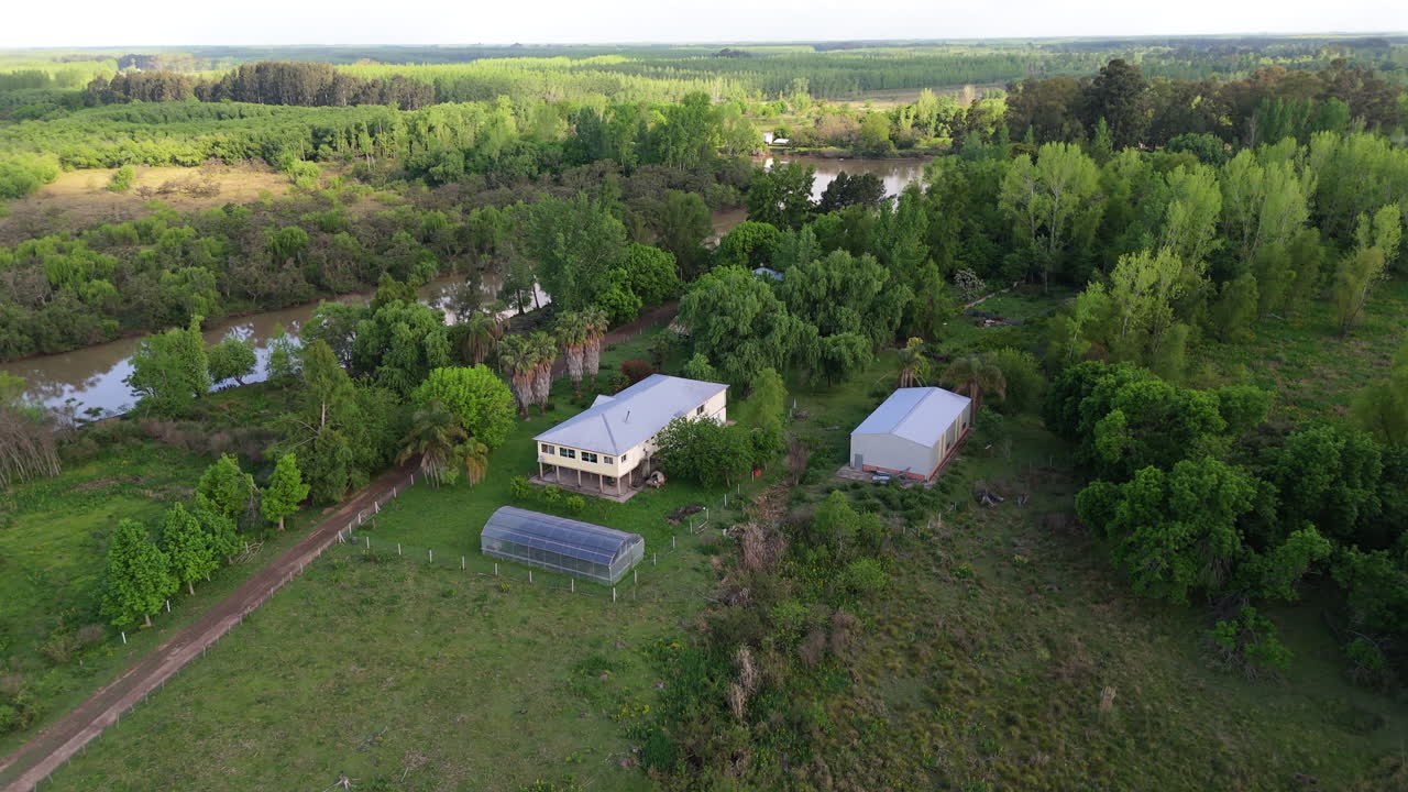 A rural school is nestled within lush green nature, captured from above, showcasing its simple charm and peaceful setting.