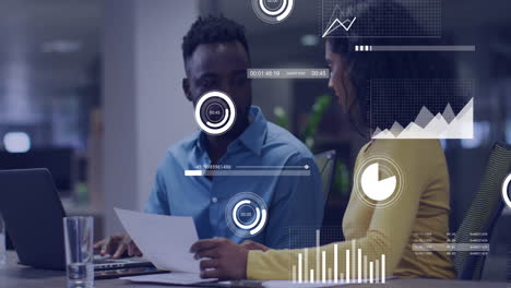 Business data analytics animation over two colleagues discussing documents in office