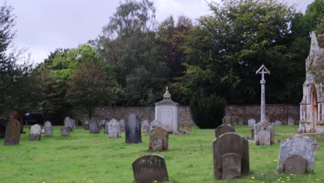 tracking right to left through church of england graveyard in small village