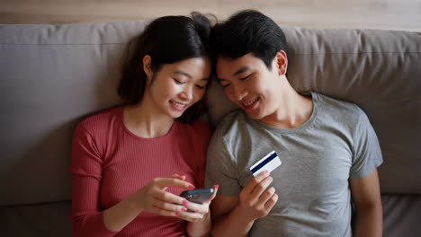 couple online shopping with credit card and smartphone