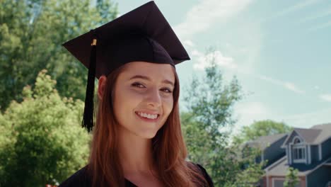 a female graduate student turns her head and smiles at the camera. low angle.