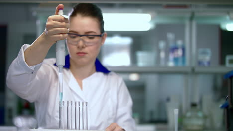 investigador que trabaja con el gotero en el laboratorio. trabajador de laboratorio que utiliza equipos de laboratorio