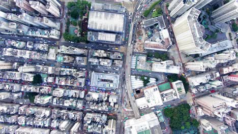 Central-Hong-Kong,-top-down-aerial-view-of-traffic-and-city-skyscrapers