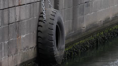 dock bumper at aarhus harbour, hangs on the side of the harbor edge