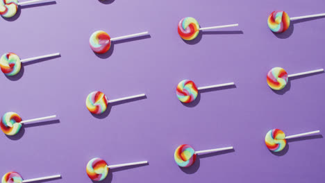 Video-of-rows-multicoloured-lollipops-on-blue-background