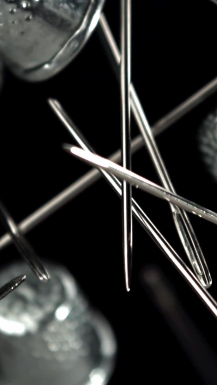 Rack Focus on Silver Sewing Needles and Thimbles