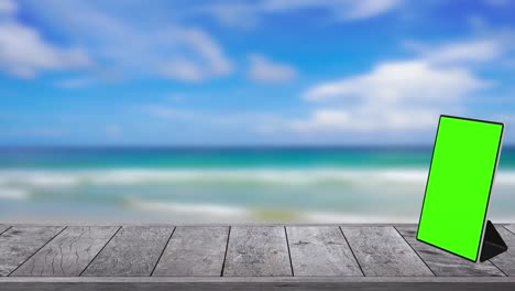 wooden table texture on the beach and monitor display on table