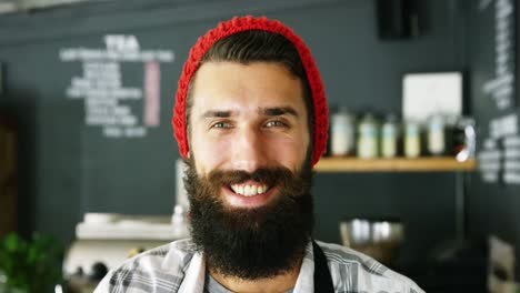 Portrait-of-waiter-standing-with-arms-crossed