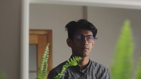 confident asian guy looking into mirror, positive the start of the day