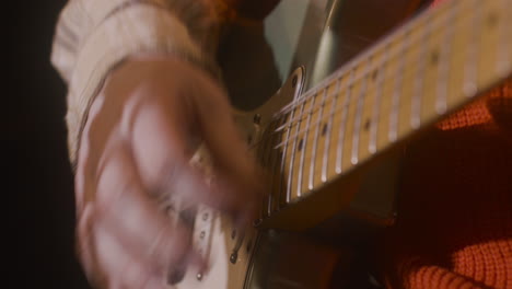 close up of an unrecognizable male musician playing guitar 2