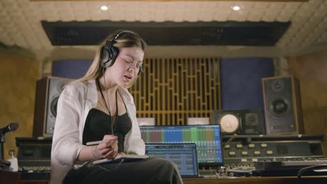 young caucasian woman working at music recording studio