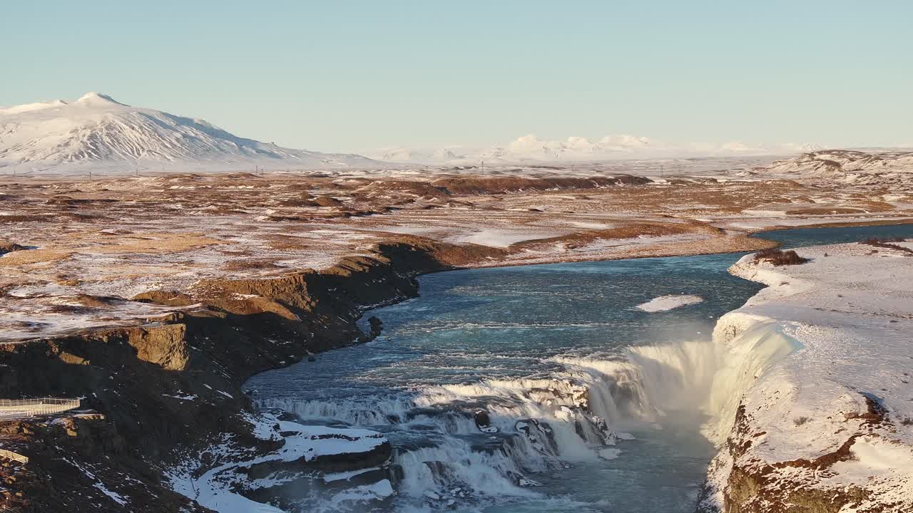 Aerial - Gullfoss waterfall surging through icy Suðurland Iceland winter