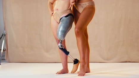 Close-Up-Of-Two-Female-Friends-One-With-Prosthetic-Limb-In-Underwear-Promoting-Body-Positivity