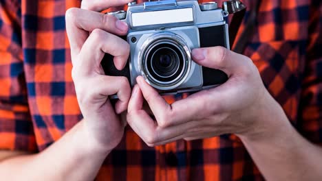 Animation-of-caucasian-man-holding-camera-over-white-background