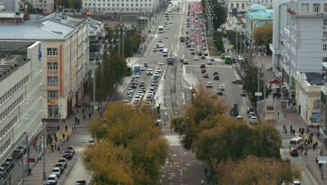 city street with traffic and autumn foliage