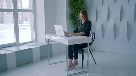 woman working on laptop in modern office