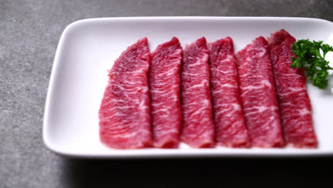 fresh beef raw sliced with marbled texture served for sukiyaki and shabu or yakiniku