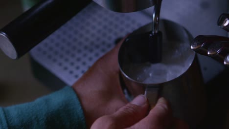 closeup of milk frothing at an espresso machine
