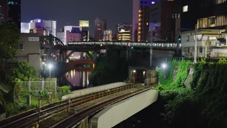 long jr train arrives at station in akihabara district of tokyo at night 4k