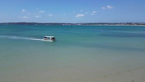 Elizabeth-castle-amphibious-ferry-approaching-the-beach-St-Helier-Jersey-aerial