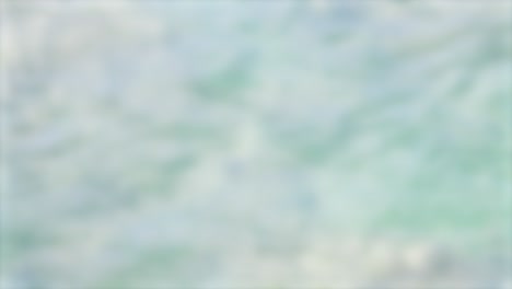 un bucle sin fisuras de ondas suaves del océano creando un fondo calmante y texturizado con movimiento sutil y tonos pastel
