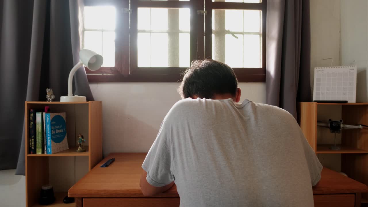 Person sitting at a desk in front of a window