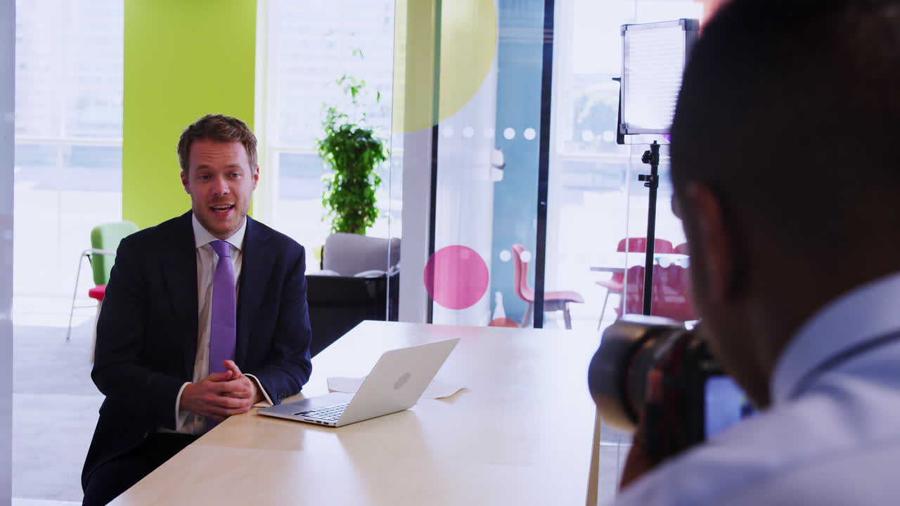 Cameraman and young businessman making instructional video