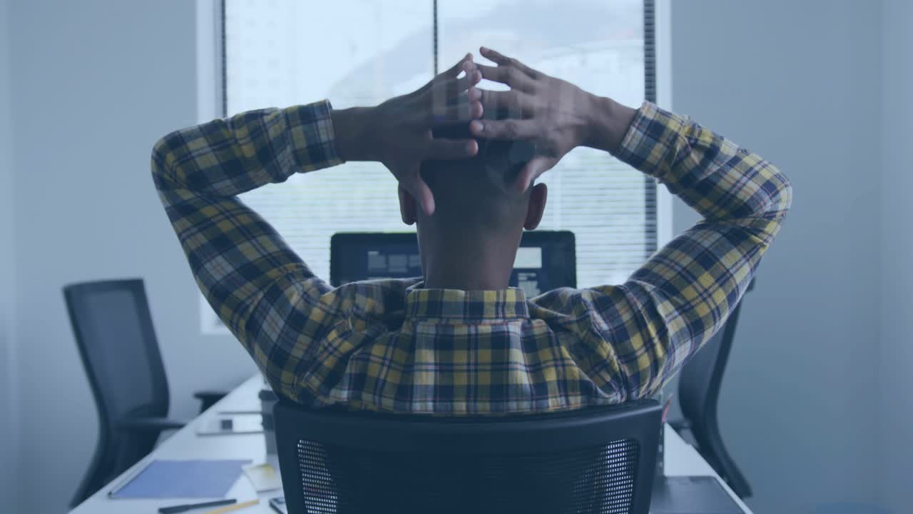 Software developer typing on keys and pausing for posture relief, stretching overhead, leaning back