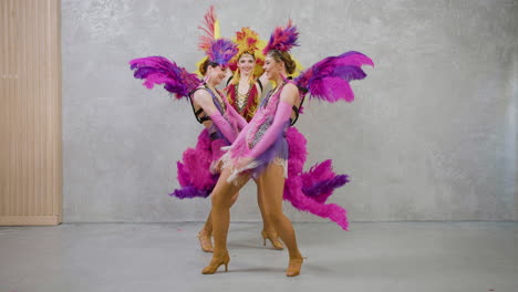 three beautiful showgirls dancing 2