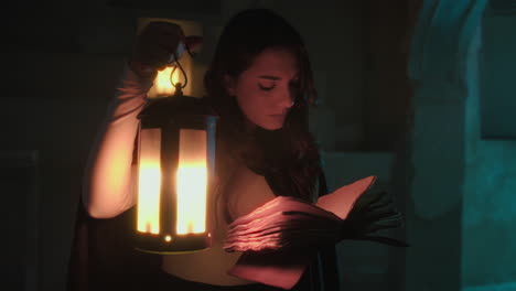 woman reads a mysterious book in a crypt with a medieval lantern