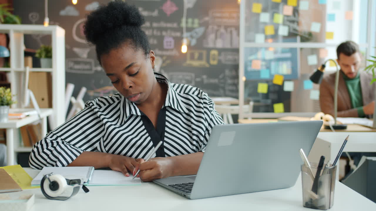 Woman Working on Laptop in Office