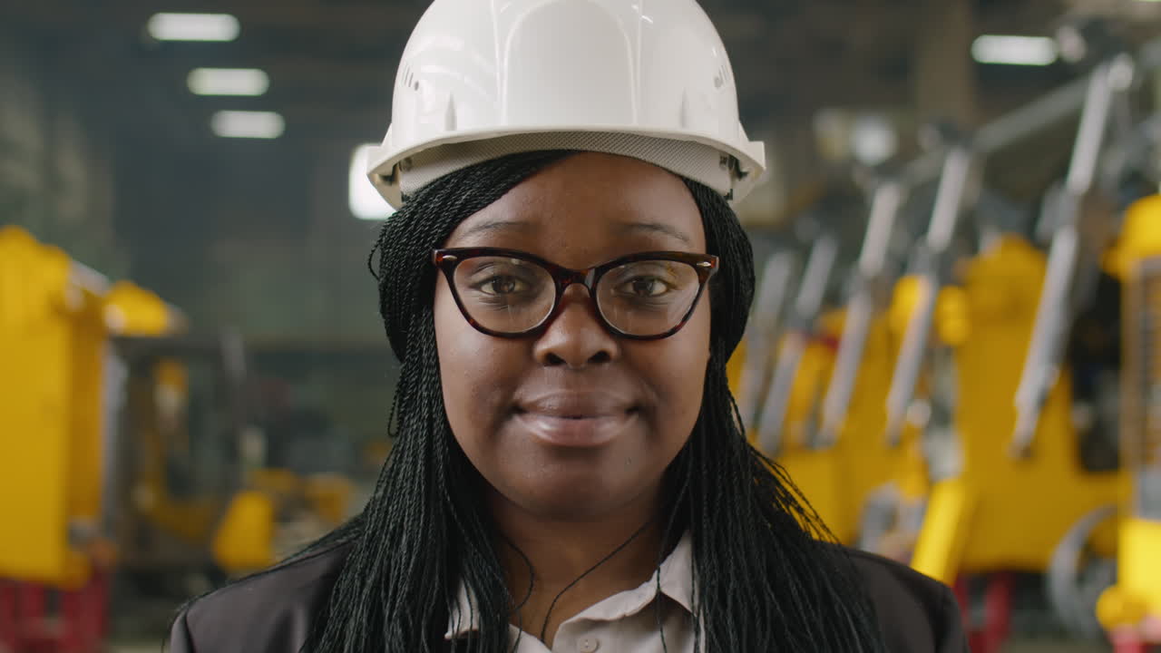 Portrait of African American Female Engineer at Heavy Equipment Factory