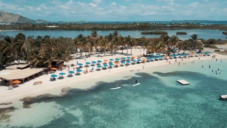 4K-Aerial-Drone-View-of-People-Paddleboarding-at-Le-Galion-Beach-in-St-Maarten-Caribbean-Island-Country-Turquoise-Blue-Water