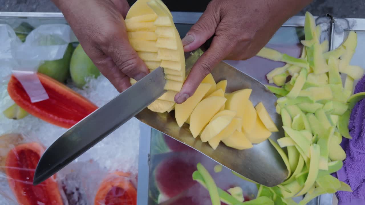 Street Vendor Slicing Mangoes and Other Tropical Fruits