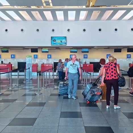 queue of people waiting at boarding gate at airport