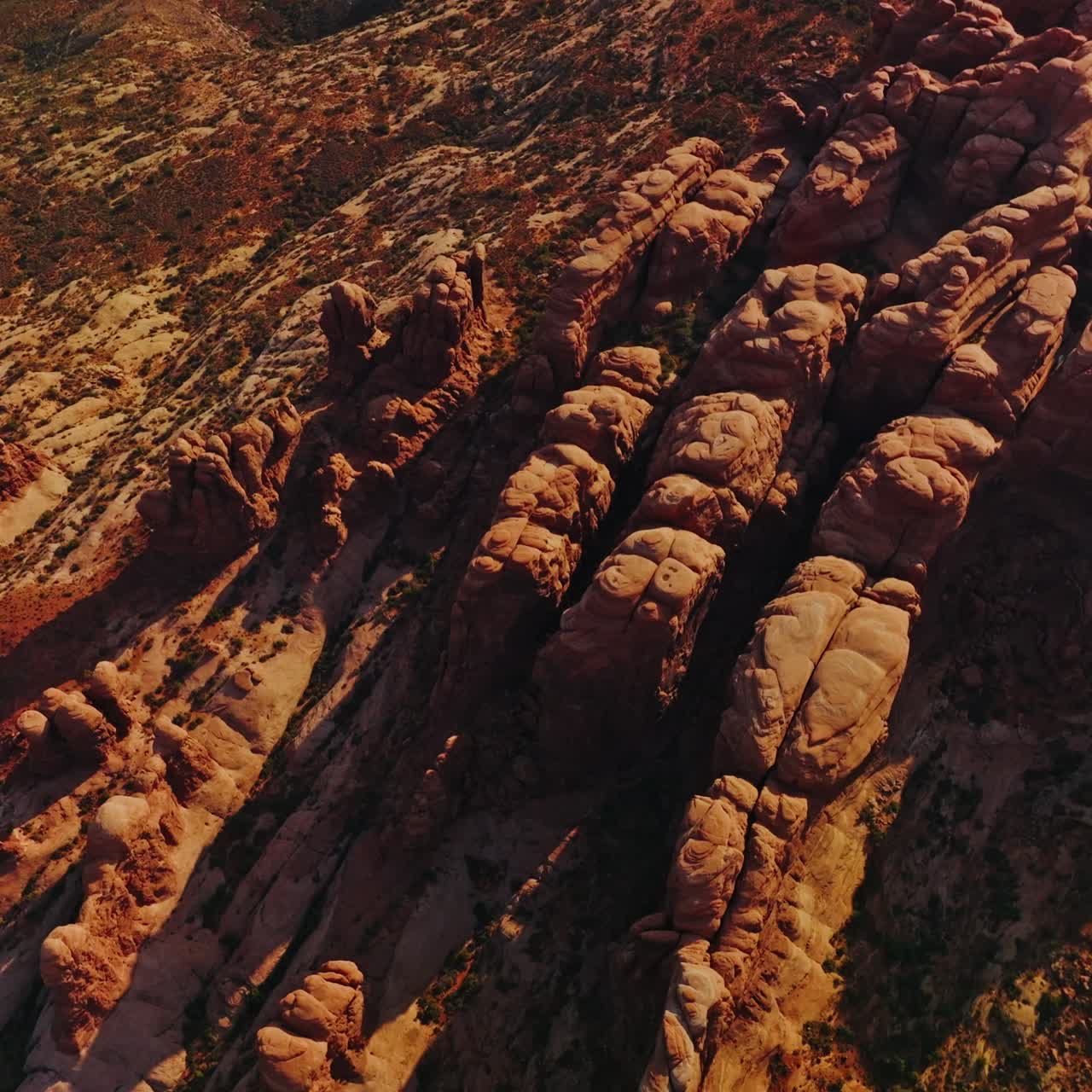 Land of rocks with no greenery and rounded mountains. Aerial view of sunny desert in Utah, USA